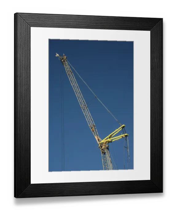 Framed Print : Construction crane against blue sky in Ystad