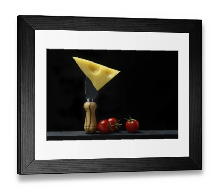 Framed Print : A piece of Swiss Emmental cheese on a cheese knife