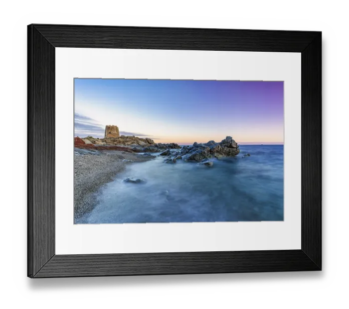 Framed Print : Old historic tower from the 16th century and rocks at sunset on the beach