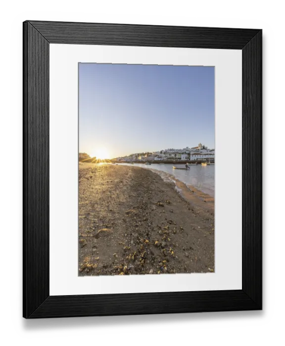 Framed Print : Sunrise on the Atlantic, skyline of a fishing village behind a harbour