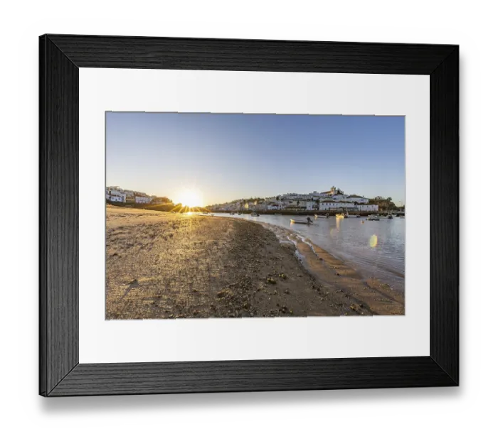 Framed Print : Sunrise on the Atlantic, skyline of a fishing village behind a harbour Framed Print : Sunrise on the Atlantic, skyline of a fishing village behind a harbour