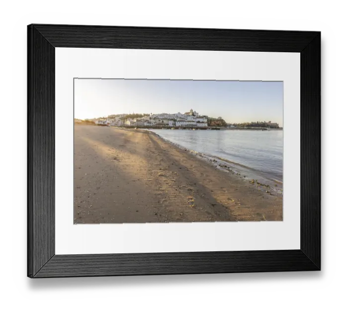 Framed Print : Sunrise on the Atlantic, skyline of a fishing village behind a harbour Framed Print : Sunrise on the Atlantic, skyline of a fishing village behind a harbour