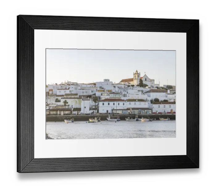 Framed Print : Sunrise on the Atlantic, skyline of a fishing village behind a harbour Framed Print : Sunrise on the Atlantic, skyline of a fishing village behind a harbour