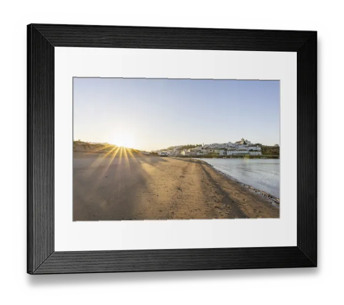 Framed Print : Sunrise on the Atlantic, skyline of a fishing village behind a harbour Framed Print : Sunrise on the Atlantic, skyline of a fishing village behind a harbour