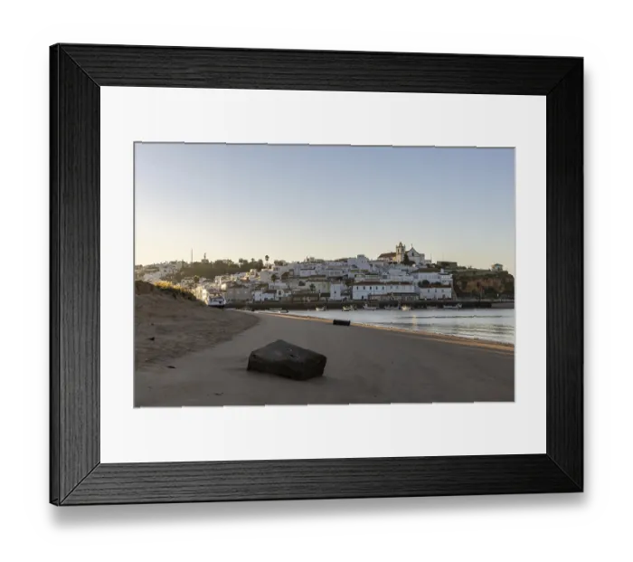 Framed Print : Sunrise on the Atlantic, skyline of a fishing village behind a harbour Framed Print : Sunrise on the Atlantic, skyline of a fishing village behind a harbour