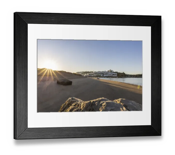 Framed Print : Sunrise on the Atlantic, skyline of a fishing village behind a harbour