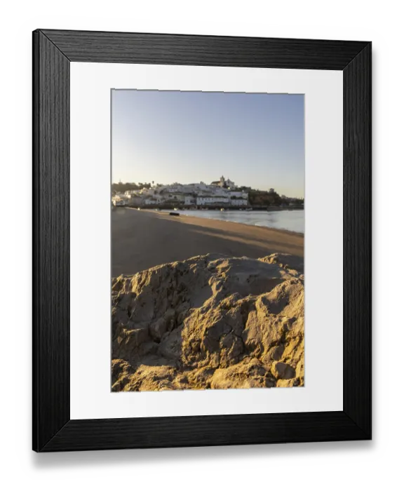 Framed Print : Sunrise on the Atlantic, skyline of a fishing village behind a harbour