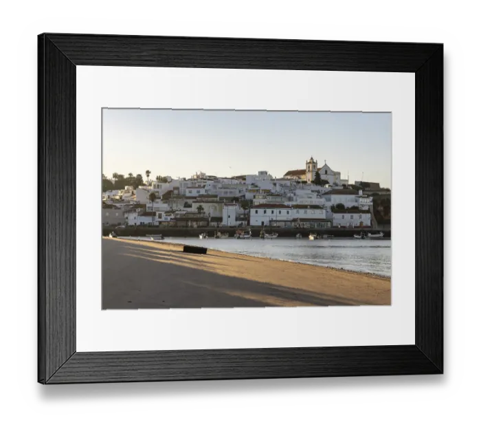 Framed Print : Sunrise on the Atlantic, skyline of a fishing village behind a harbour Framed Print : Sunrise on the Atlantic, skyline of a fishing village behind a harbour