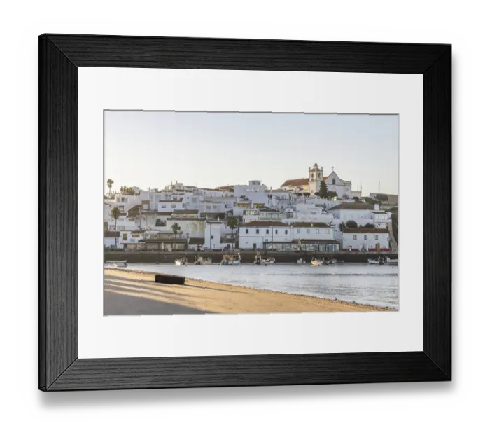 Framed Print : Sunrise on the Atlantic, skyline of a fishing village behind a harbour Framed Print : Sunrise on the Atlantic, skyline of a fishing village behind a harbour