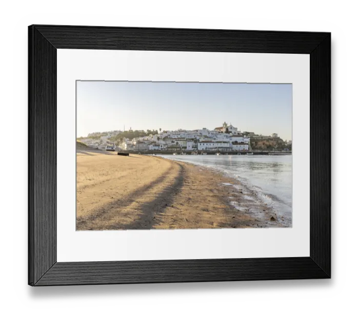 Framed Print : Sunrise on the Atlantic, skyline of a fishing village behind a harbour Framed Print : Sunrise on the Atlantic, skyline of a fishing village behind a harbour