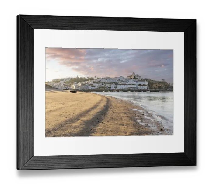 Framed Print : Sunrise on the Atlantic, skyline of a fishing village behind a harbour