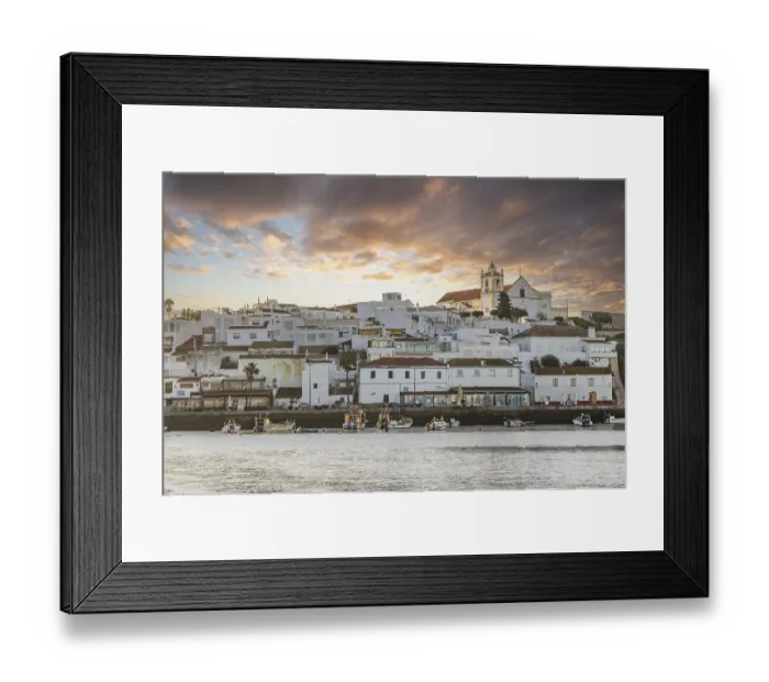 Framed Print : Sunrise on the Atlantic, skyline of a fishing village behind a harbour Framed Print : Sunrise on the Atlantic, skyline of a fishing village behind a harbour