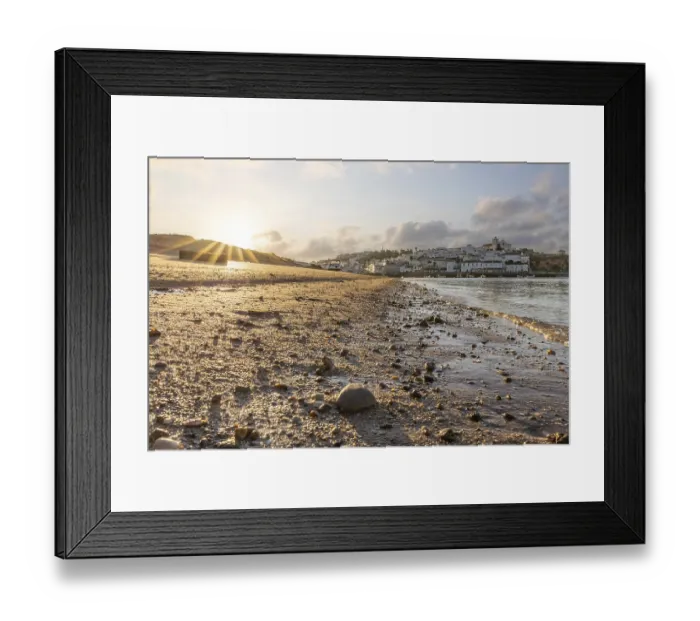 Framed Print : Sunrise on the Atlantic, skyline of a fishing village behind a harbour