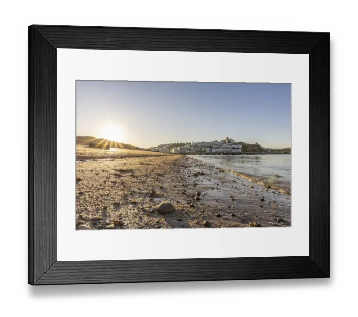 Framed Print : Sunrise on the Atlantic, skyline of a fishing village behind a harbour Framed Print : Sunrise on the Atlantic, skyline of a fishing village behind a harbour