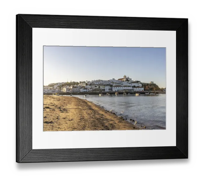 Framed Print : Sunrise on the Atlantic, skyline of a fishing village behind a harbour Framed Print : Sunrise on the Atlantic, skyline of a fishing village behind a harbour