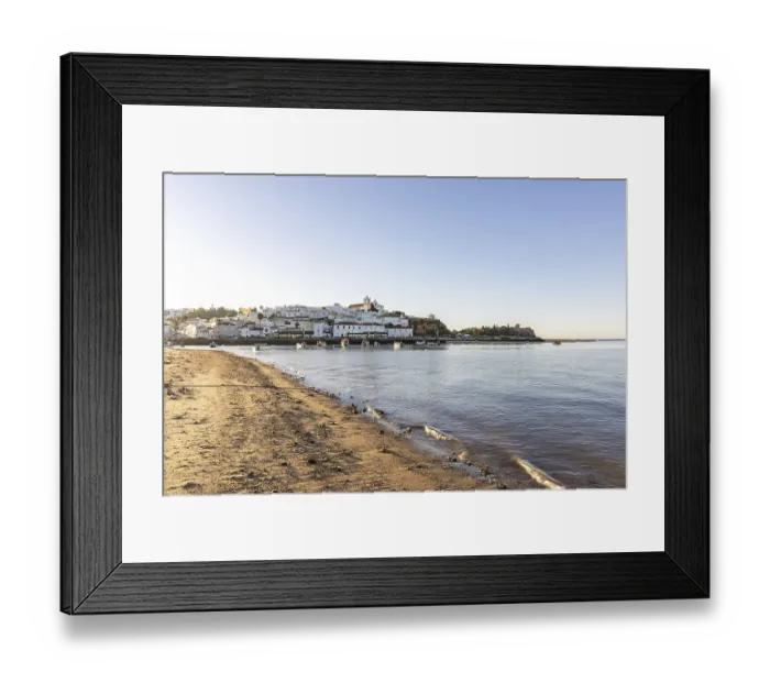 Framed Print : Sunrise on the Atlantic, skyline of a fishing village behind a harbour Framed Print : Sunrise on the Atlantic, skyline of a fishing village behind a harbour