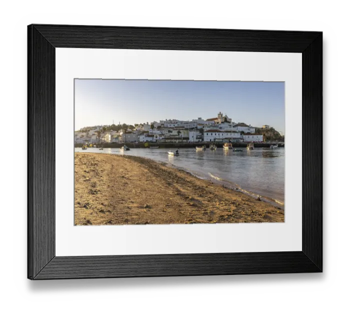 Framed Print : Sunrise on the Atlantic, skyline of a fishing village behind a harbour Framed Print : Sunrise on the Atlantic, skyline of a fishing village behind a harbour