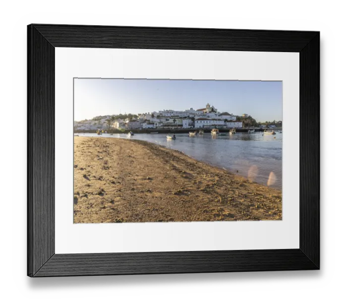 Framed Print : Sunrise on the Atlantic, skyline of a fishing village behind a harbour Framed Print : Sunrise on the Atlantic, skyline of a fishing village behind a harbour