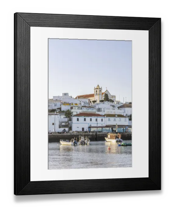Framed Print : Sunrise on the Atlantic, skyline of a fishing village behind a harbour Framed Print : Sunrise on the Atlantic, skyline of a fishing village behind a harbour