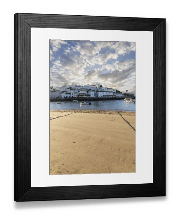 Framed Print : Sunrise on the Atlantic, skyline of a fishing village behind a harbour Framed Print : Sunrise on the Atlantic, skyline of a fishing village behind a harbour