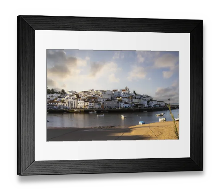Framed Print : Sunrise on the Atlantic, skyline of a fishing village behind a harbour