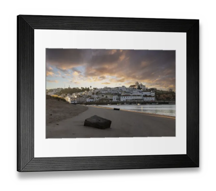 Framed Print : Sunrise on the Atlantic, skyline of a fishing village behind a harbour