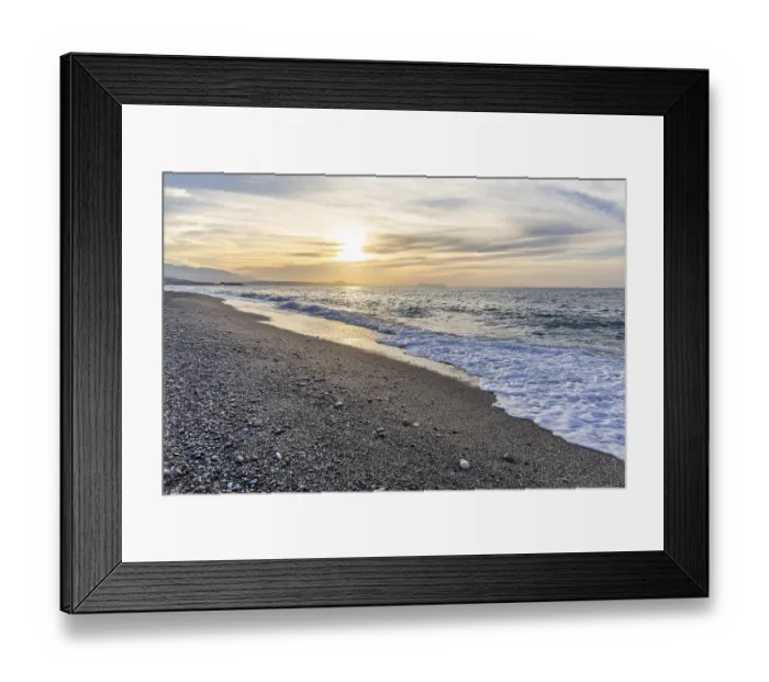 Framed Print : Beautiful coastline with a sandy beach and pebble beach at sunset