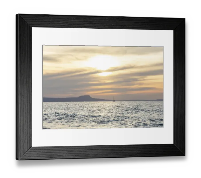 Framed Print : Beautiful coastline with a sandy beach and pebble beach at sunset Framed Print : Beautiful coastline with a sandy beach and pebble beach at sunset