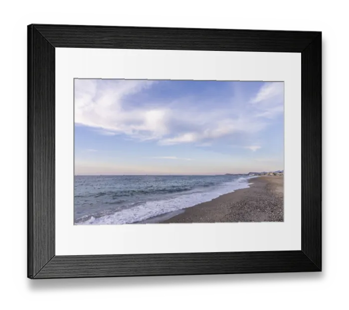Framed Print : Beautiful coastline with a sandy beach and pebble beach at sunset