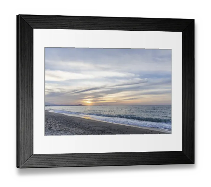 Framed Print : Beautiful coastline with a sandy beach and pebble beach at sunset