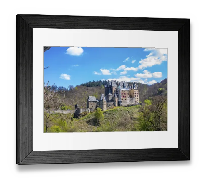 Framed Print : Castle in the valley surrounded by a green beech forest