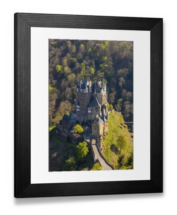Framed Print : Castle in the valley surrounded by a green beech forest