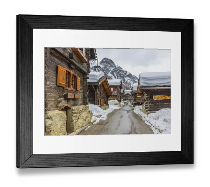 Framed Print : Street with historic old snow-covered wooden houses