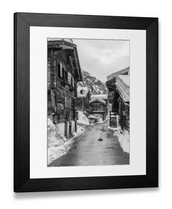 Framed Print : Street with historic old snow-covered wooden houses