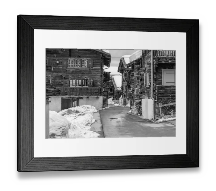 Framed Print : Street with historic old snow-covered wooden houses