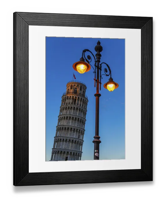 Framed Print : The Leaning Tower under an illuminated street lamp in the evening light