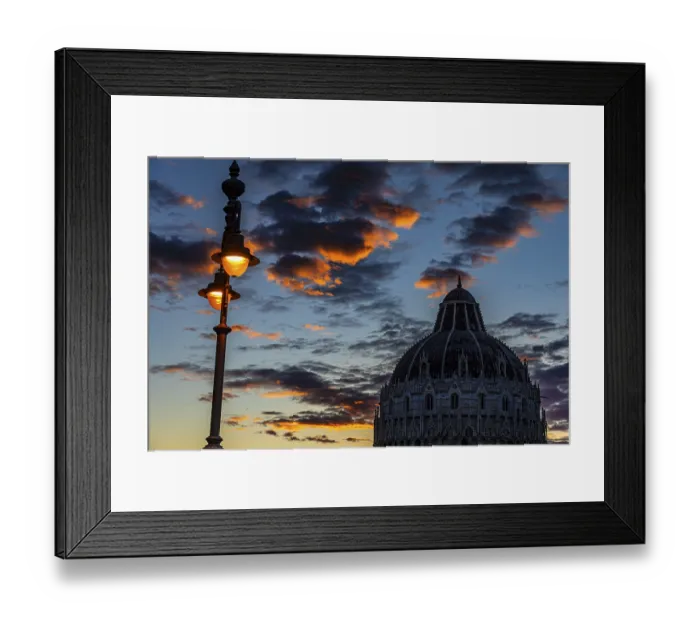 Framed Print : Baptistery chapel under an illuminated street lamp at sunset