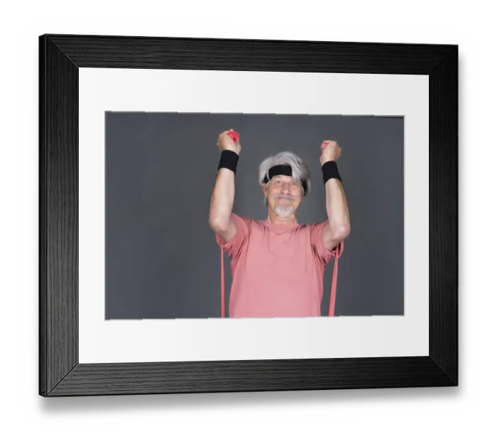 Framed Print : Elderly man with fitness outfit trains with fitness band