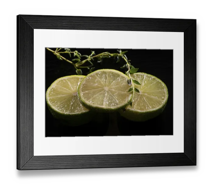 Framed Print : Three lime slices with green decoration on a stone plate