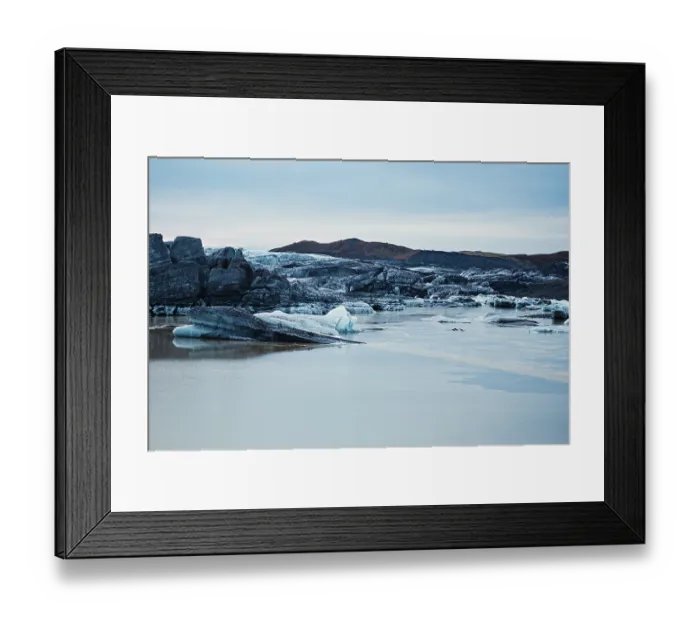 Framed Print : Calm, icy landscape with rocks and a blue sky