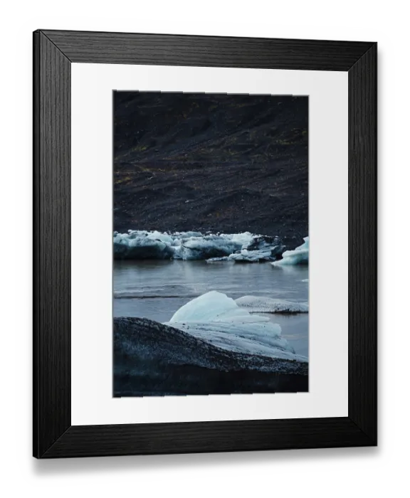 Framed Print : Chunks of blue ice floating in water with dark Framed Print : Chunks of blue ice floating in water with dark