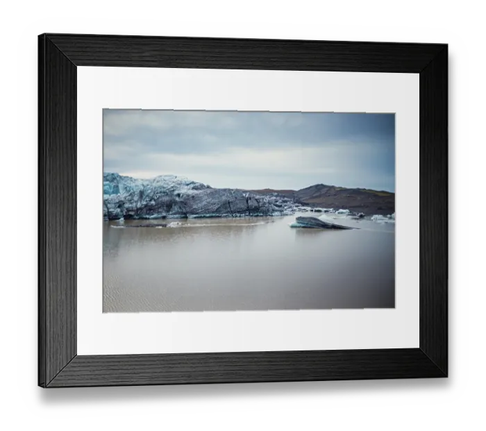 Framed Print : Serene landscape with icebergs and rocky terrain surrounding still water
