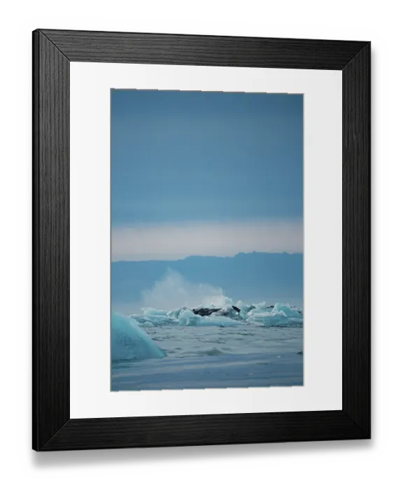 Framed Print : Splashes among icebergs in a dynamic ocean scene under a cold sky