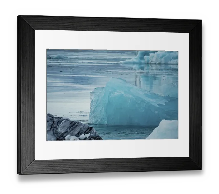 Framed Print : Large textured iceberg floating in a serene body of water