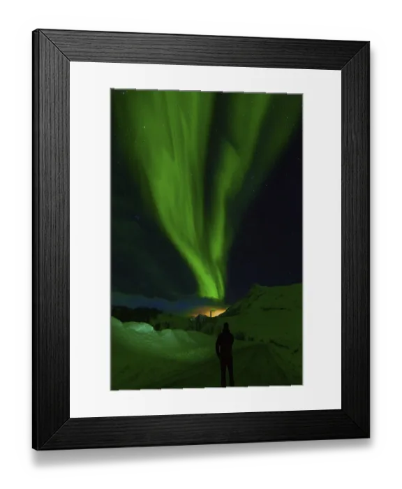 Framed Print : Person observes striking green aurora borealis against a clear starry night