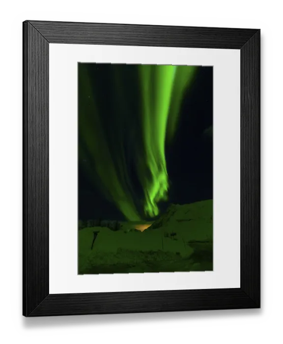 Framed Print : Radiant green aurora borealis streaks across a star-filled sky