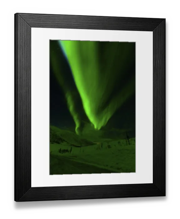 Framed Print : Glowing green aurora borealis fills the sky over a snowy landscape under a starry backdrop