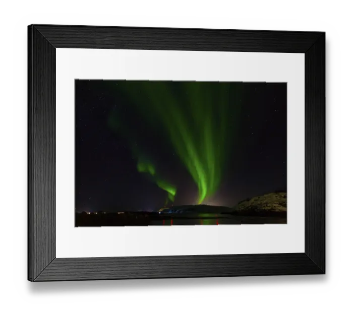Framed Print : A calm scene where green auroras dance across the night sky reflected in water