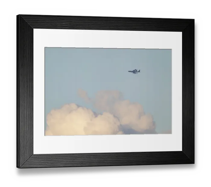 Framed Print : Boeing E-3 Sentry aircraft flying above white clouds in the sky Framed Print : Boeing E-3 Sentry aircraft flying above white clouds in the sky