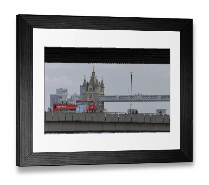 Framed Print : Red double decker bus driving over a bridge with Tower bridge in the background